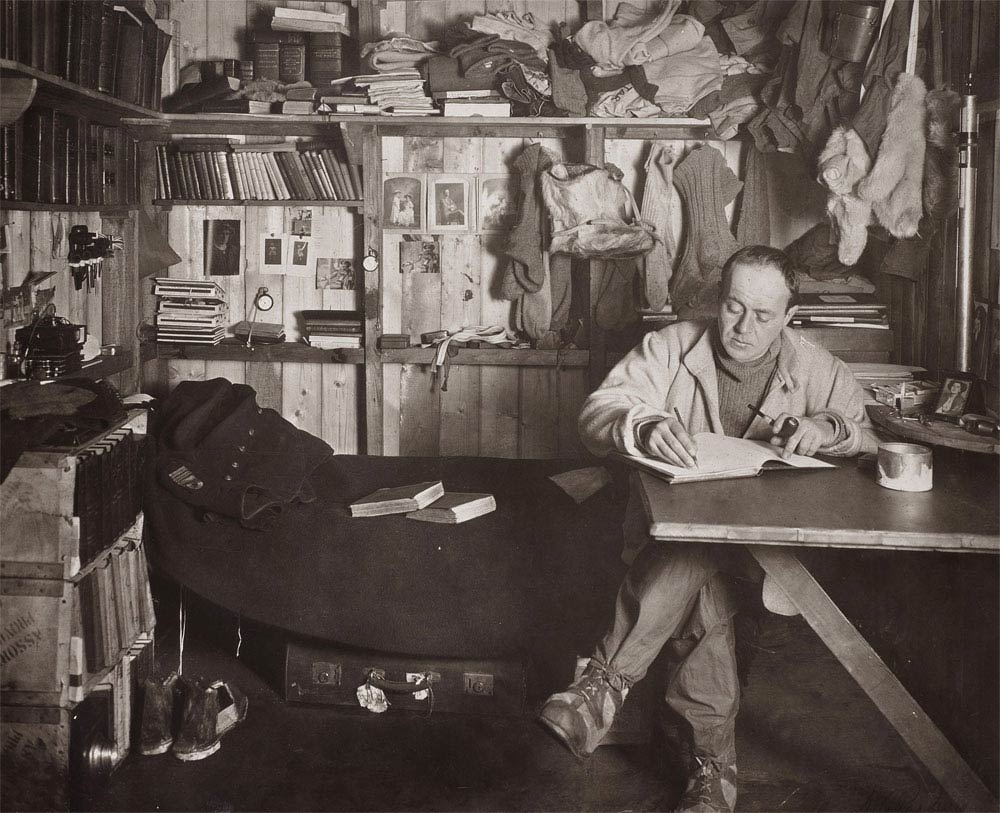 Robert Falcon Scott working on his journal, from his Cape Evans hut, 1911